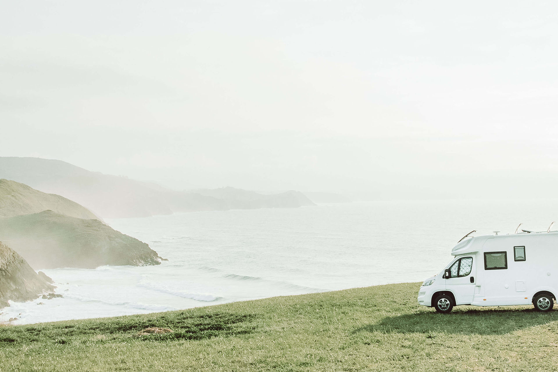 White RV parked on the coastline